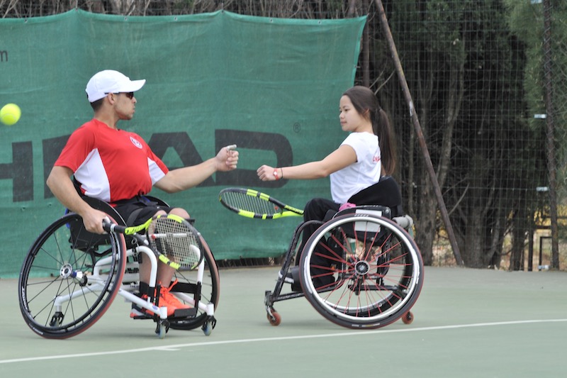 Wheelchair tennis mixed ATP WTA doubles team bumping fists