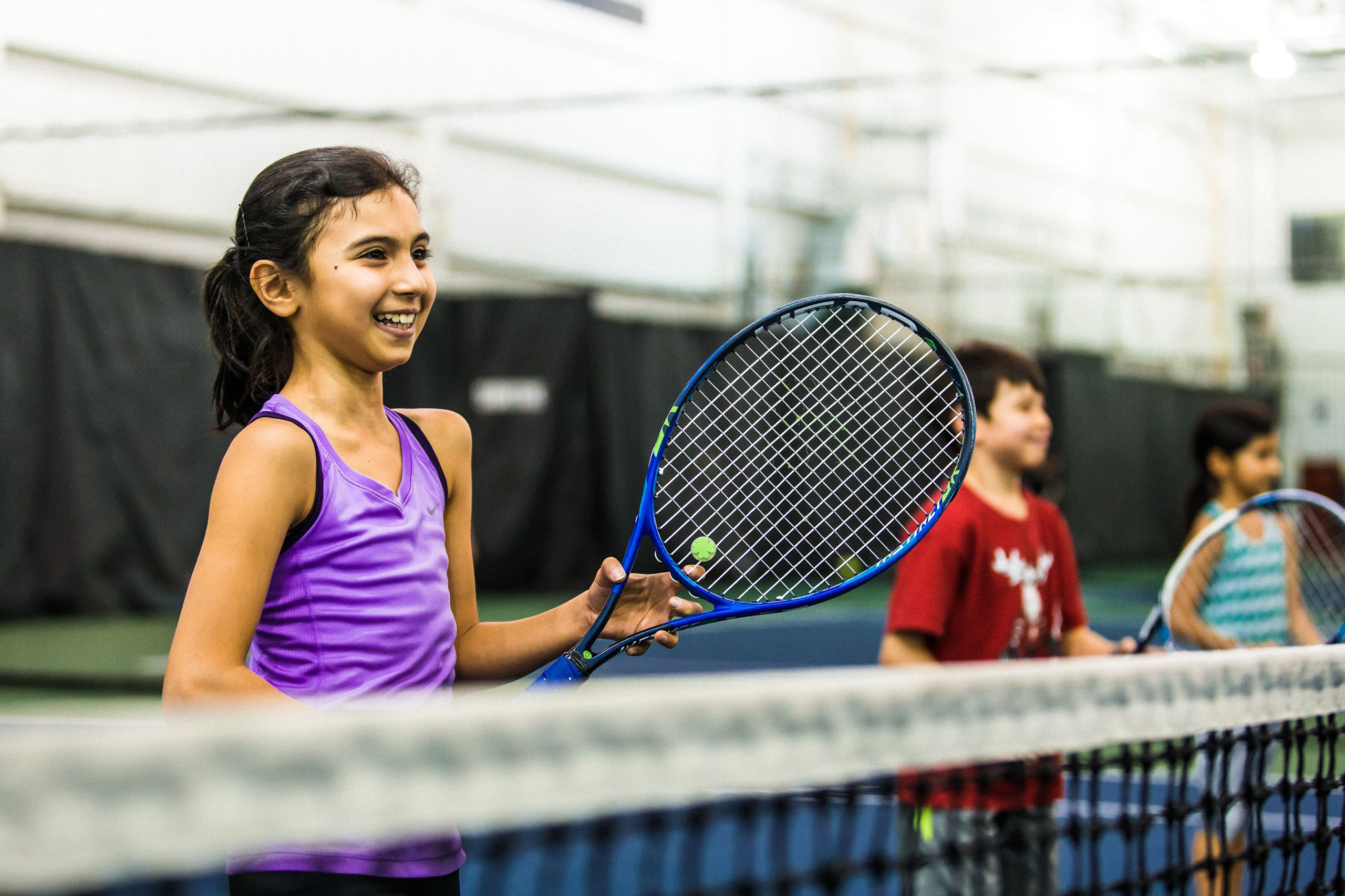 Smiling children on tennis court
