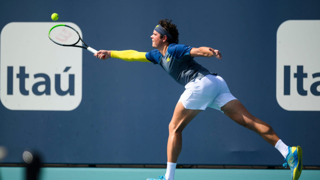 Milos Raonic stretches for a forehand