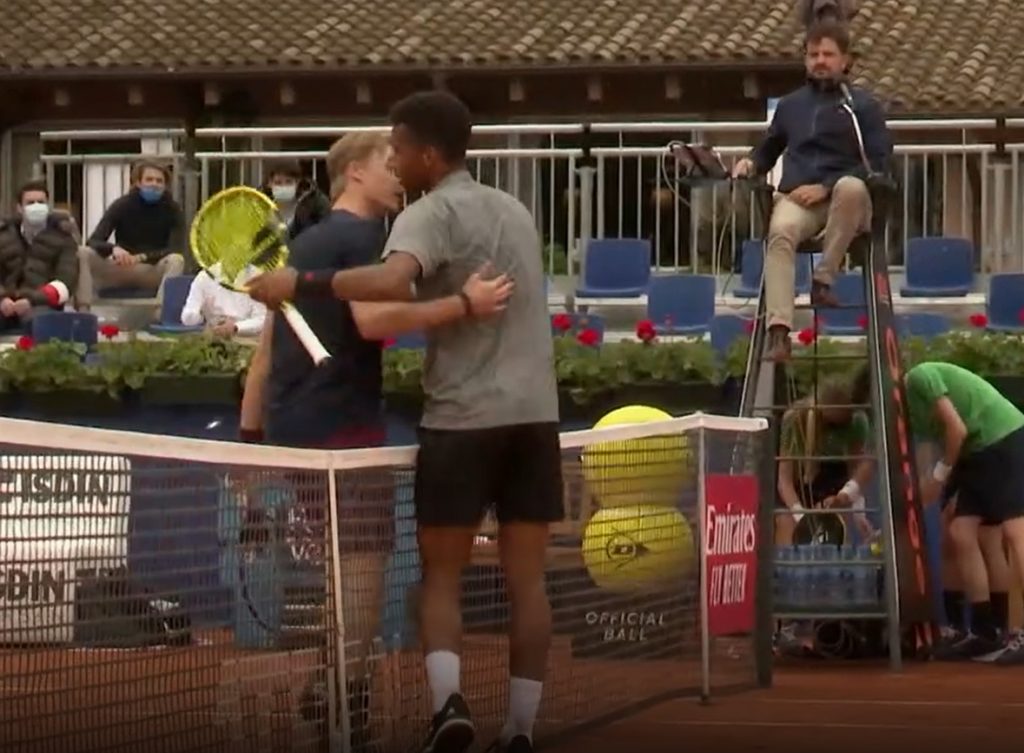 Felix and Denis hug and talk at the net, post match