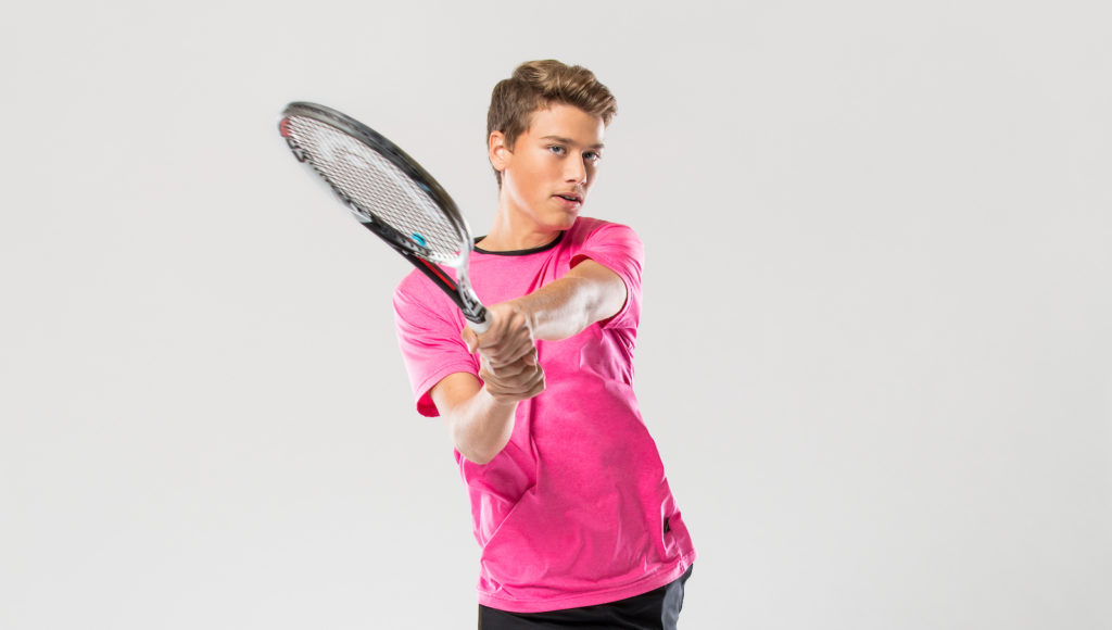Simeunovic makes the backhand motion in a studio photoshoot
