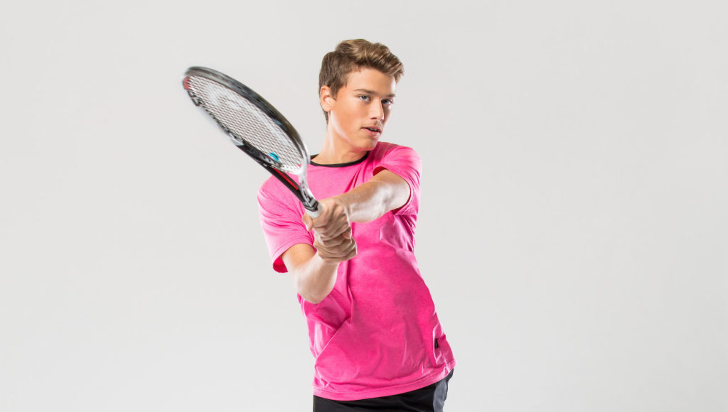 Simeunovic enacts a backhand motion in a studio photoshoot