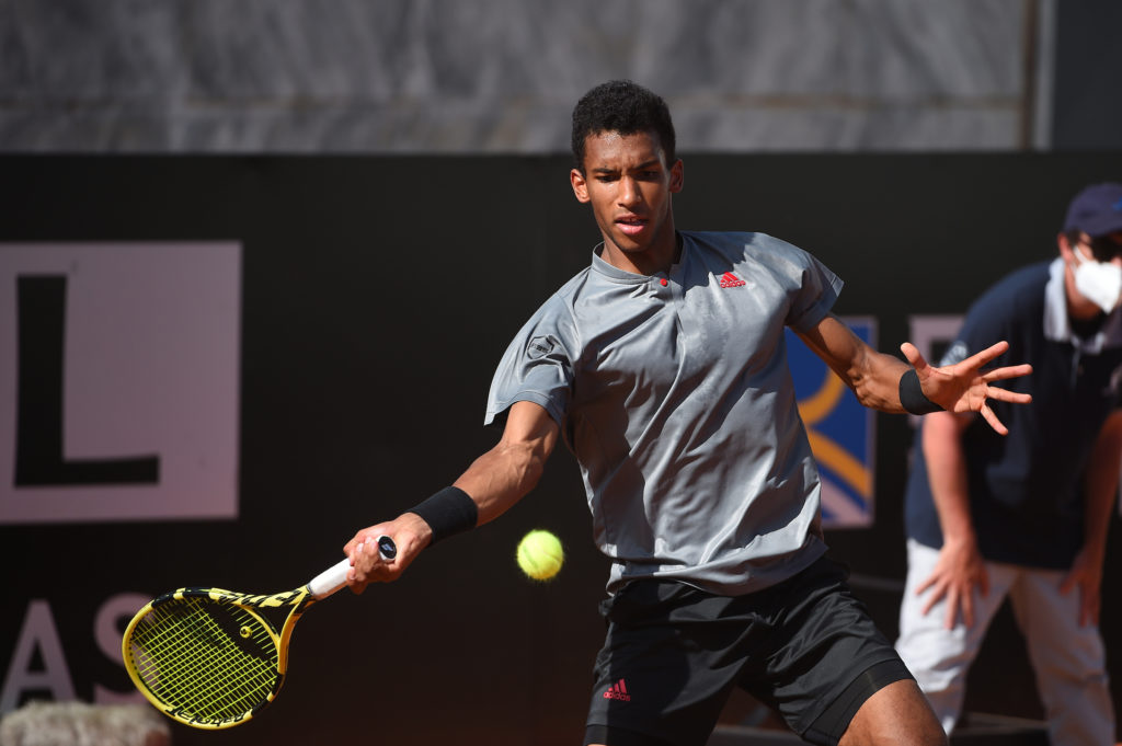 Felix Auger-Aliassime hits a forehand