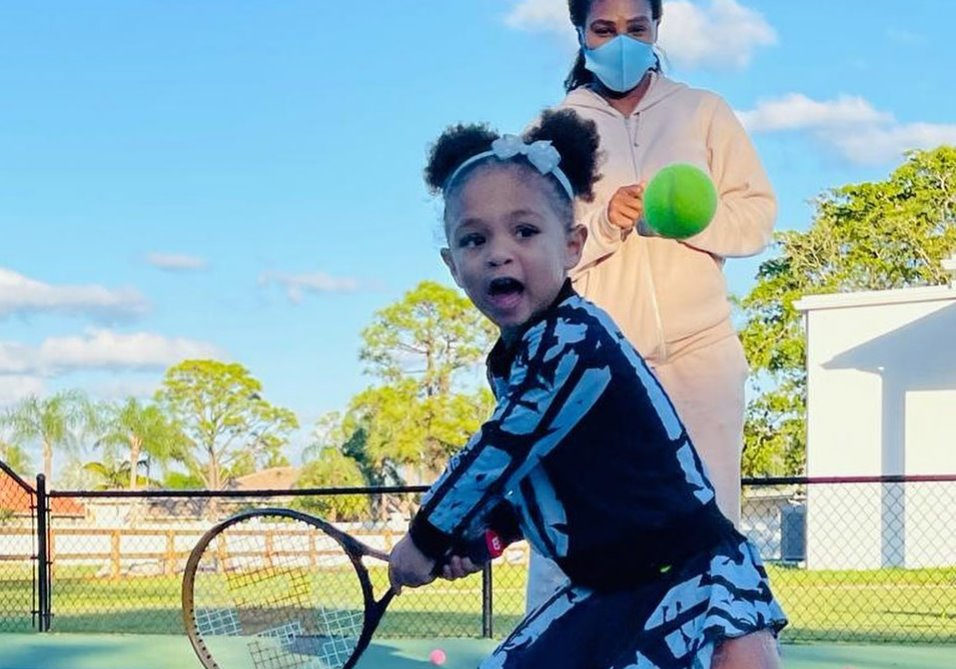 Serena Williams watches on court as Olympia, her daughter, plays tennis