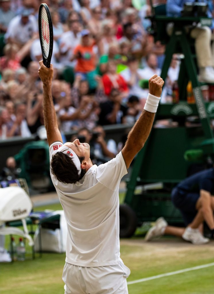 Roger Federer Puts his arms up in celebration on Centre Court, Wimbledon