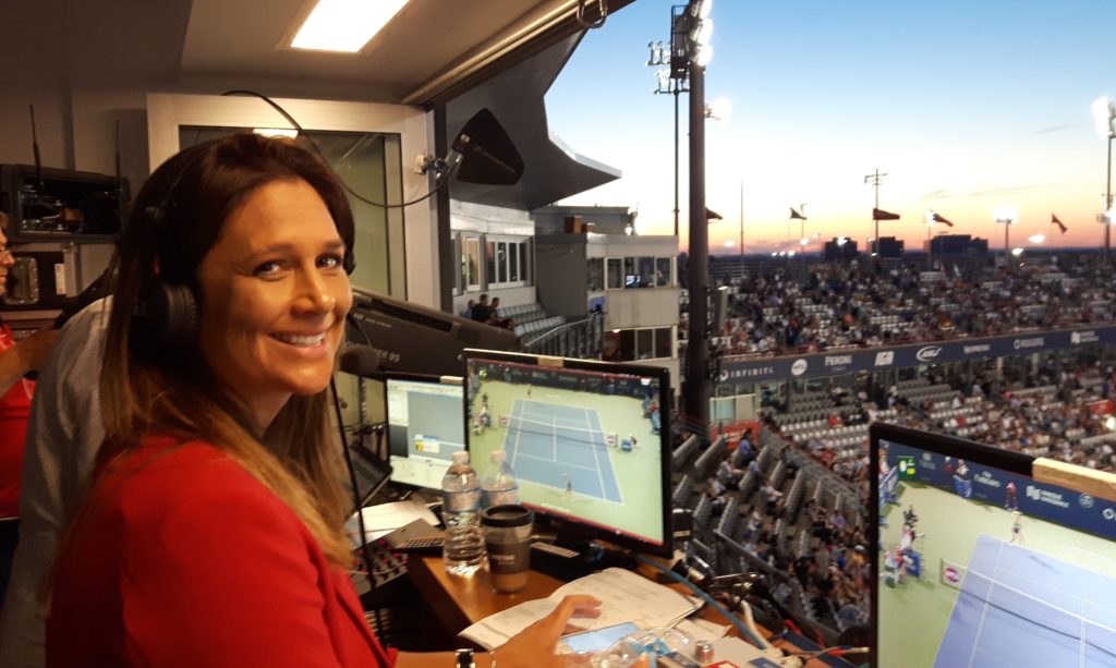 Marie Eve Pelletier smiles at the camera in the commentators booth at the montreal IGA stadium