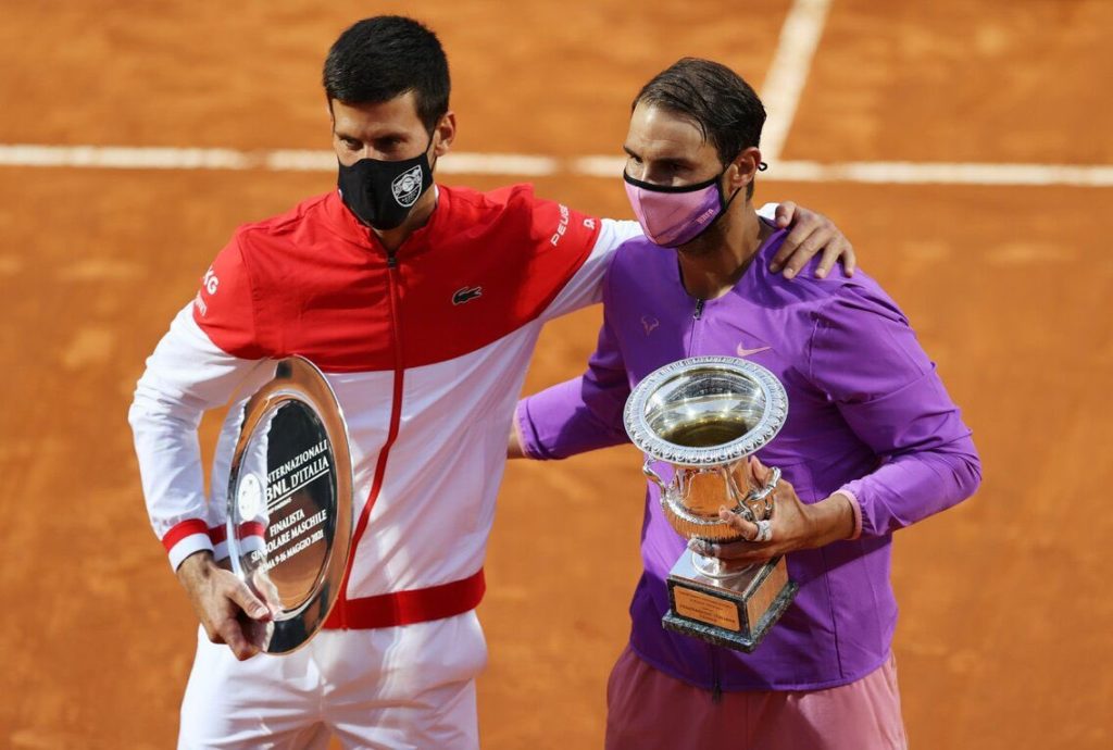 Djokovic and Nadal stand side by side with the Runner-up and Champion trophies, respectively, in Rome