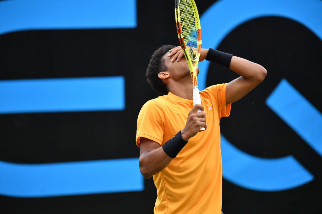Felix Auger Aliassime puts his hand on his face in frustration