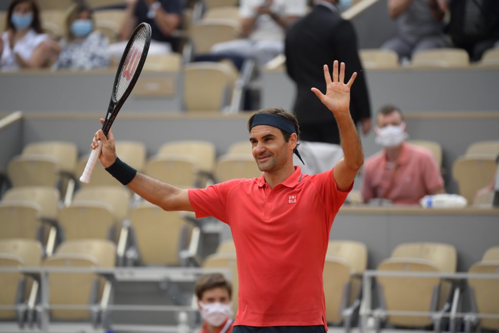 Federer waves at the crowd after a win