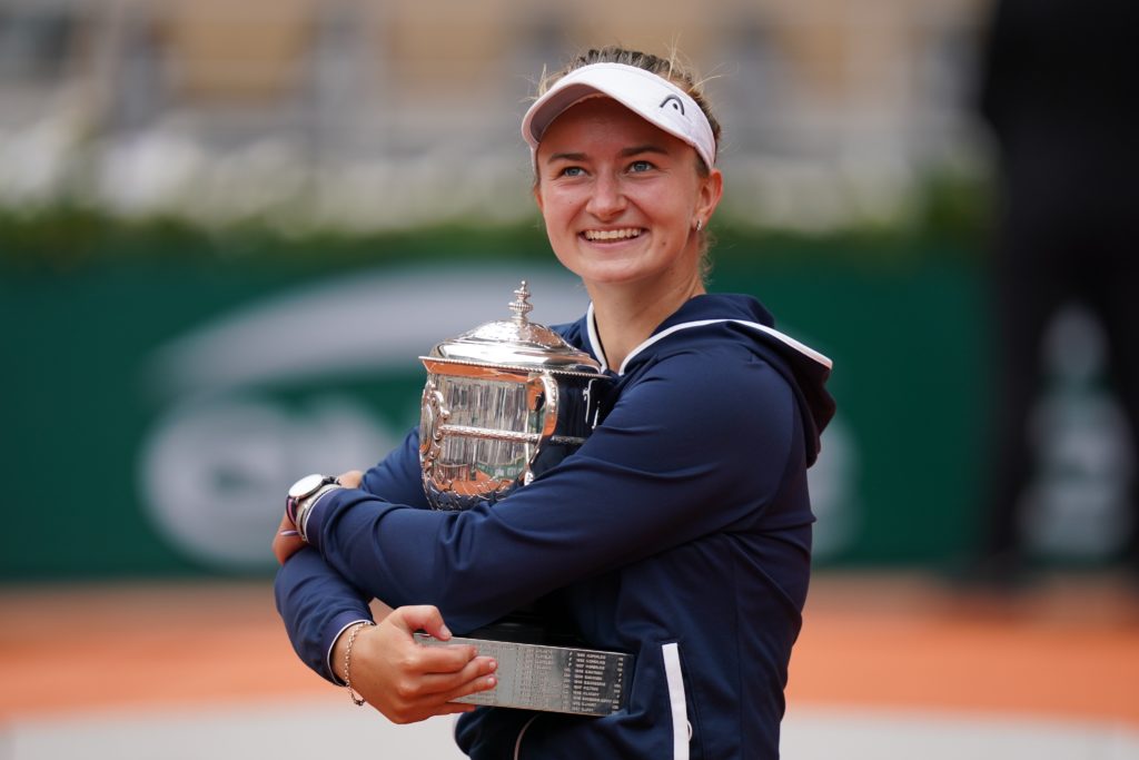 Barbora Krejcikova smiles and holds the Roland Garros trophy