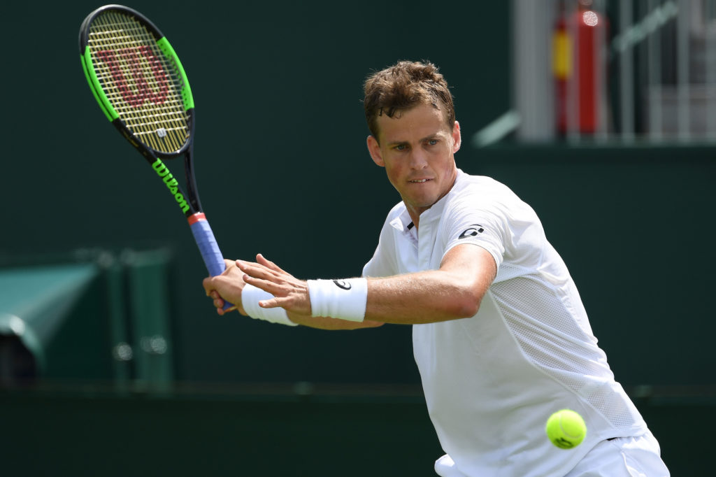 vasek pospisil winds up for a forehand at wimbledon 2019