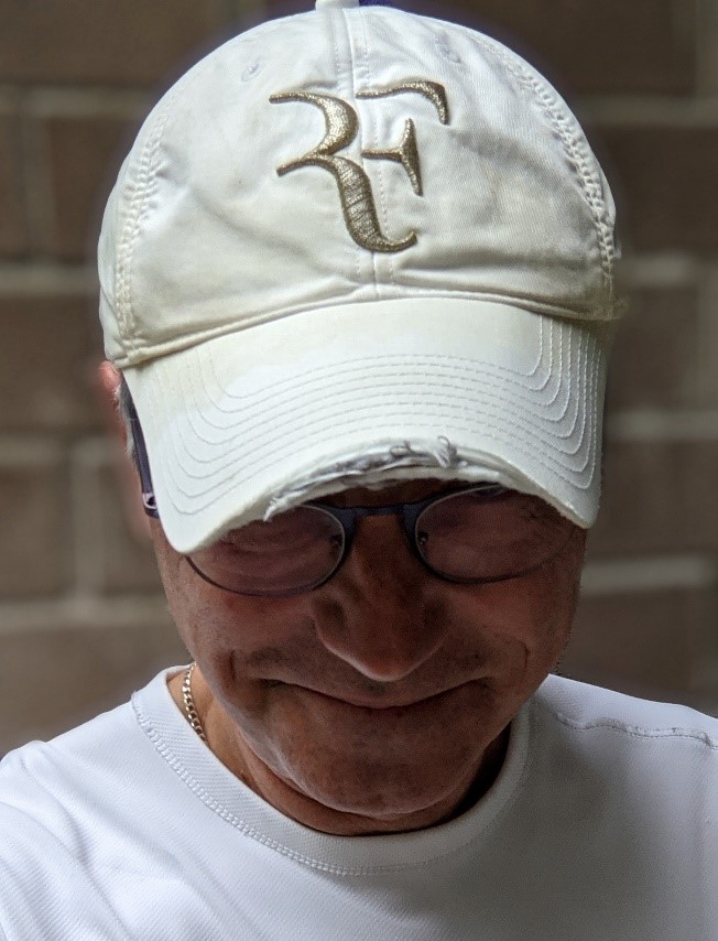 Paul RIvard wearing his ild Roger Federer hat