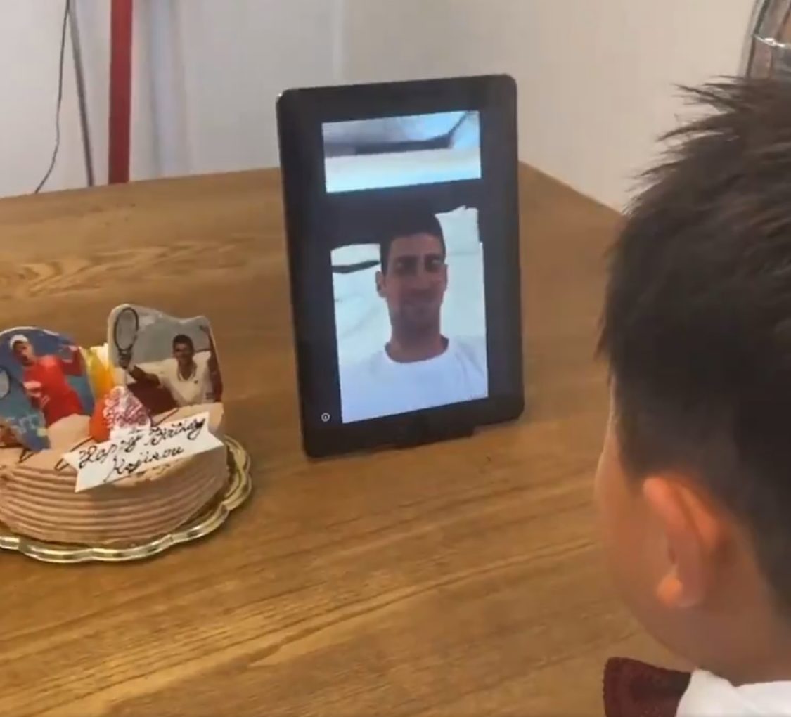Djokvovic in a tablet screen wishing happy birthday to a Japanese kid
