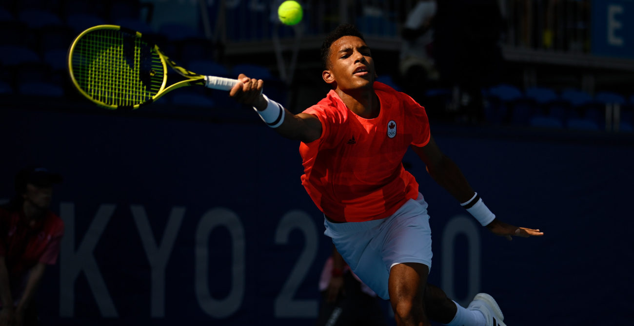 Félix AugerAliassime stretches to hit a forehand in the Tokyo Olympics