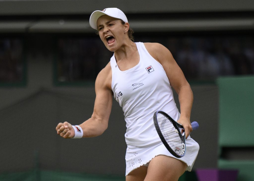 Ash Barty punches the air in celebration after winning a match