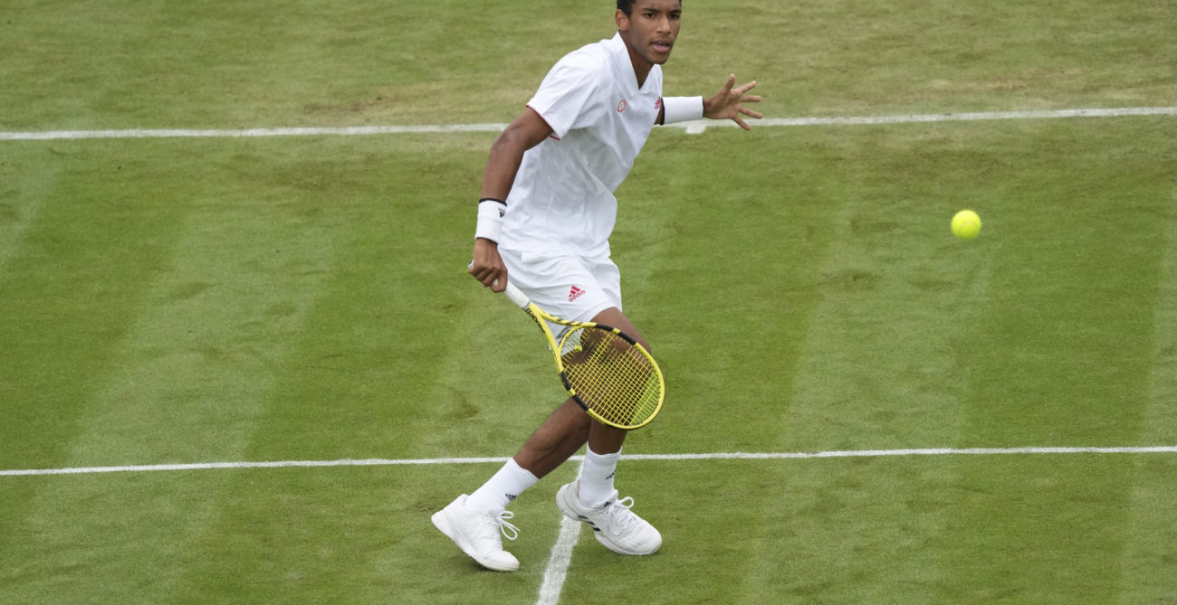 Felix Auger-Aliassime watches a volley he just hit.