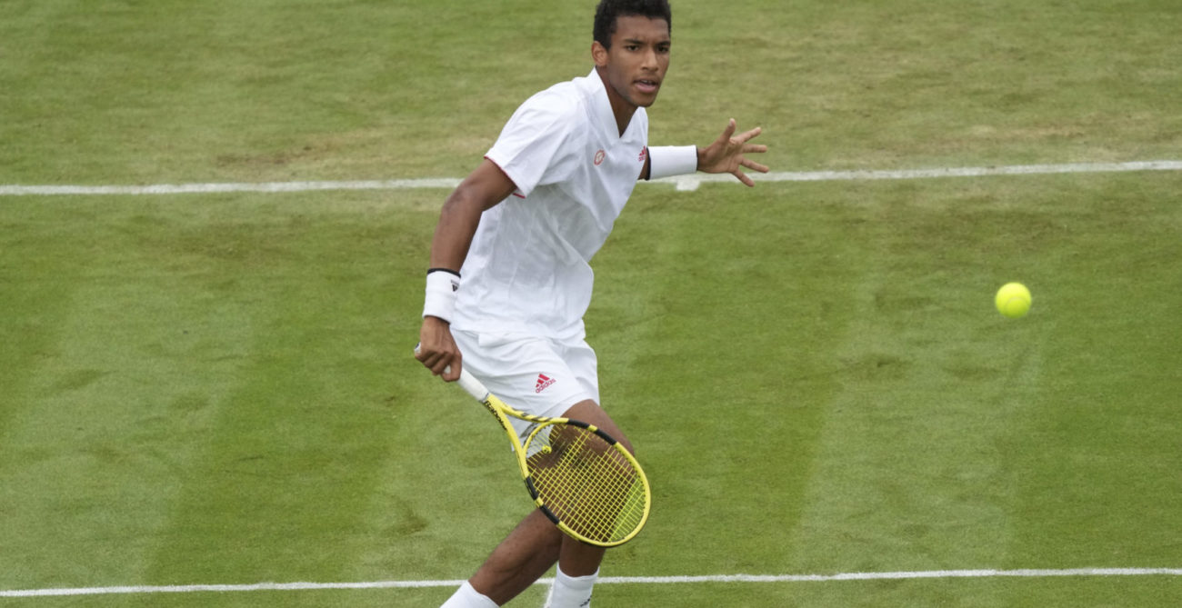 Felix Auger-Aliassime watches a volley he just hit.