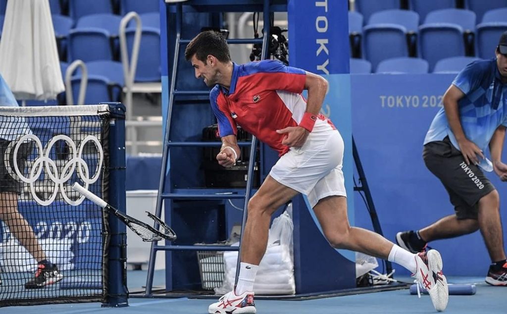 Novak Djokovic smashes his racket during the Olympics in Tokyo