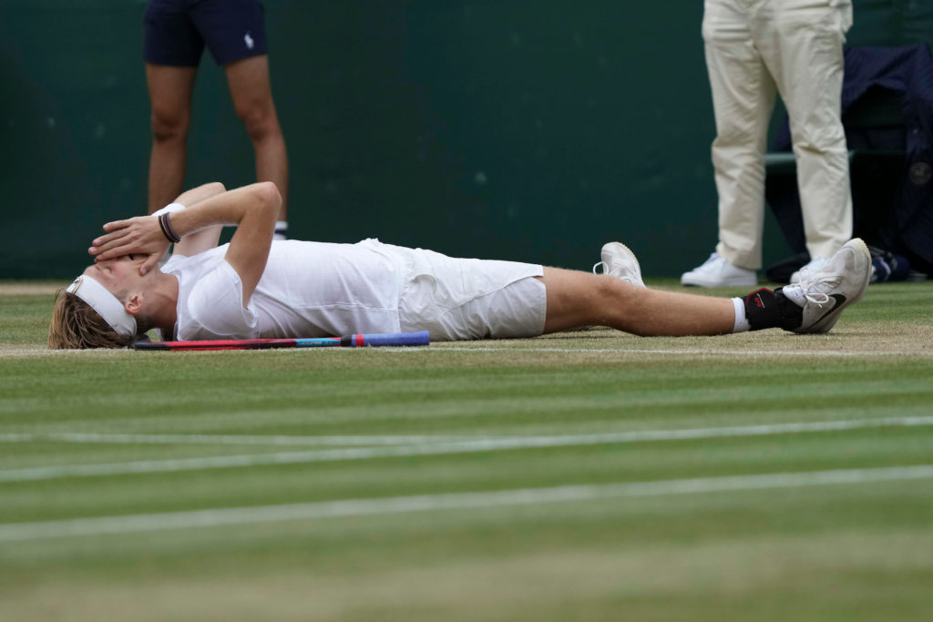 Shapovalov on the ground at Centre Court Wimbledon with his hands on his face