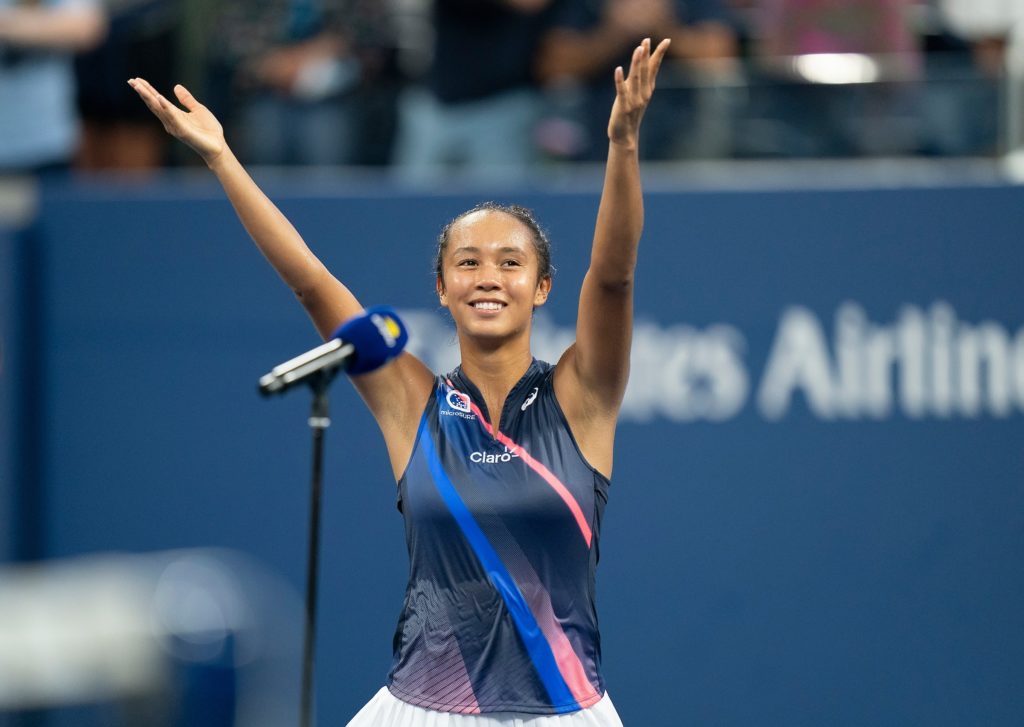 Leylah Fernandez smiles with her arms open towards the crowd at the US Open
