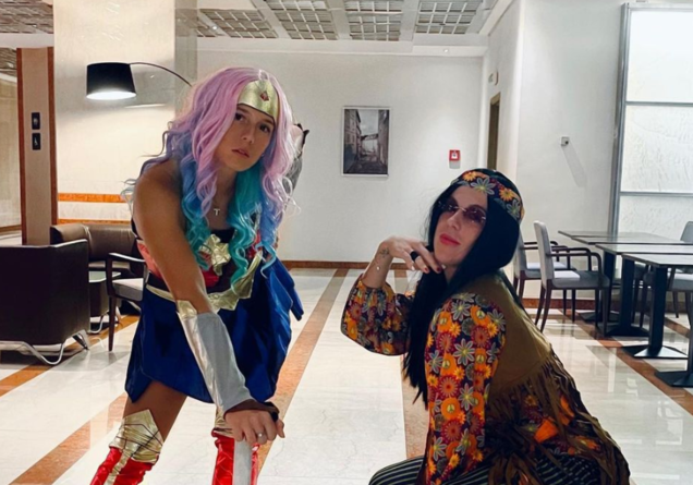 Daria Kasatkina dressed as Wonder Woman and Anastasia Pavlyuchenkova dressed as Janis Joplin pose for the camera.