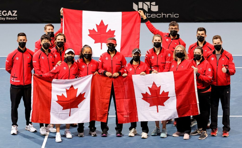 The Canadian Billie Jean King Cup team holds up Canadian flags