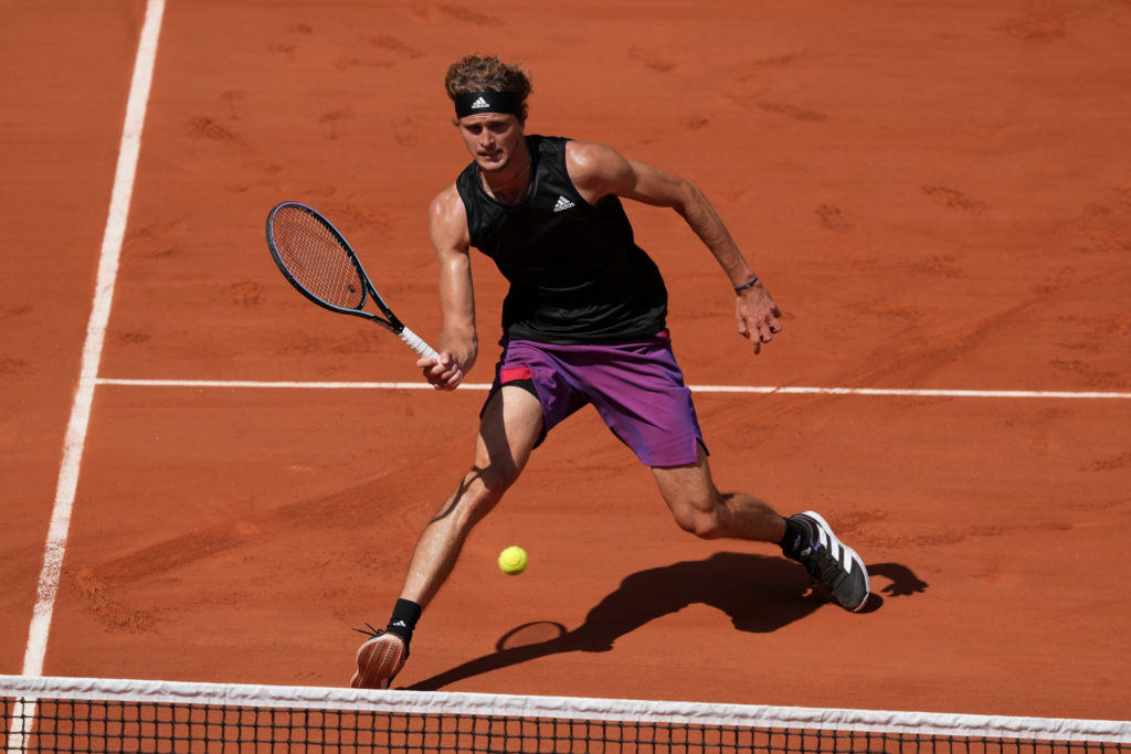Zverev hits a forehand close to the net on clay court