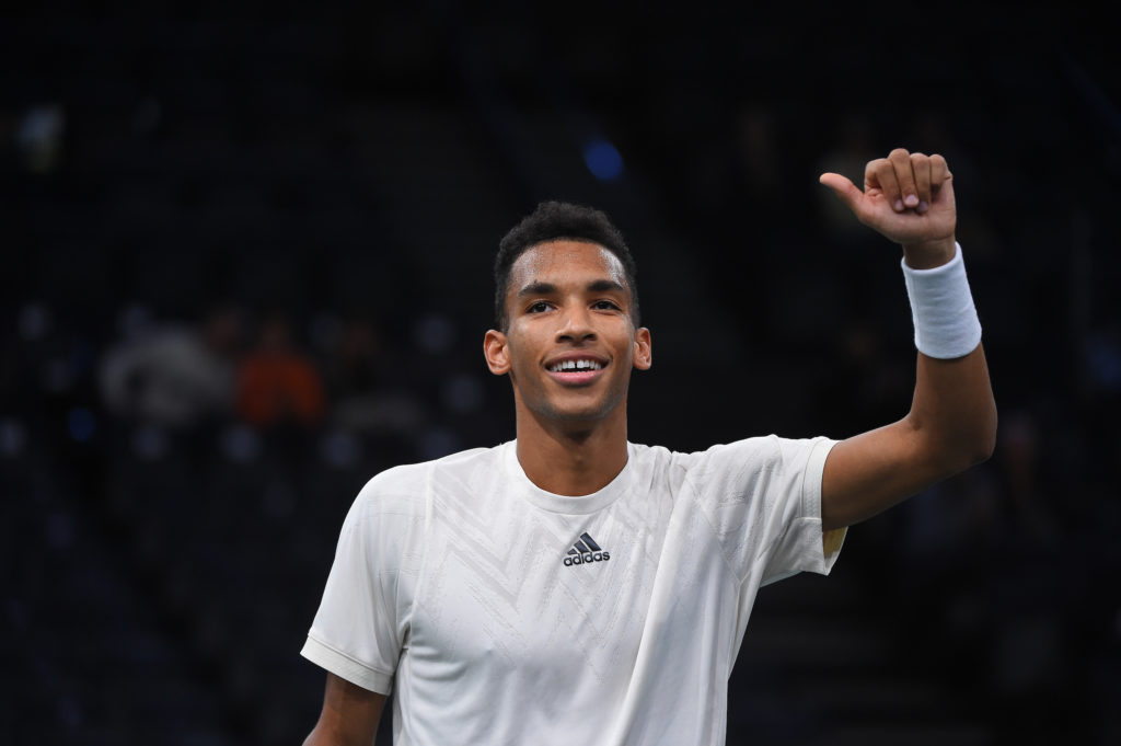 Felix Auger-Aliassime smiles and puts his thumbs up for the crowd