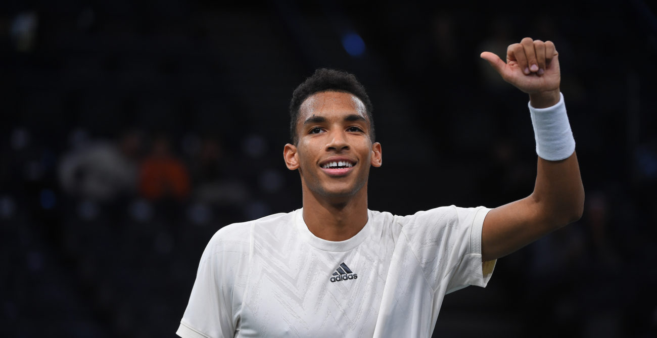 Felix Auger-Aliassime smiles and puts his thumbs up for the crowd