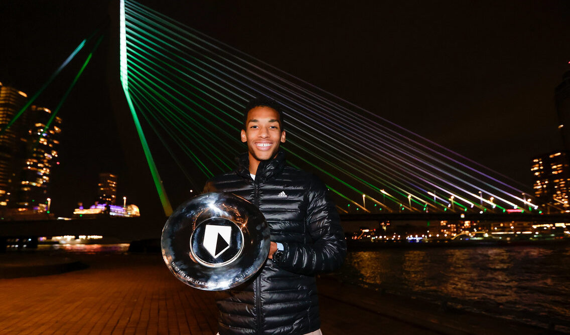 felix auger aliassime holding first singles title trophy