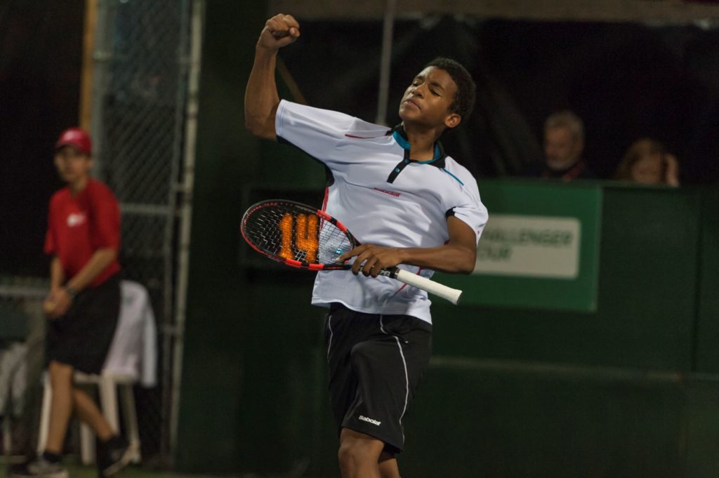Young Felix AUger Aliassime jumps in the air in celebration