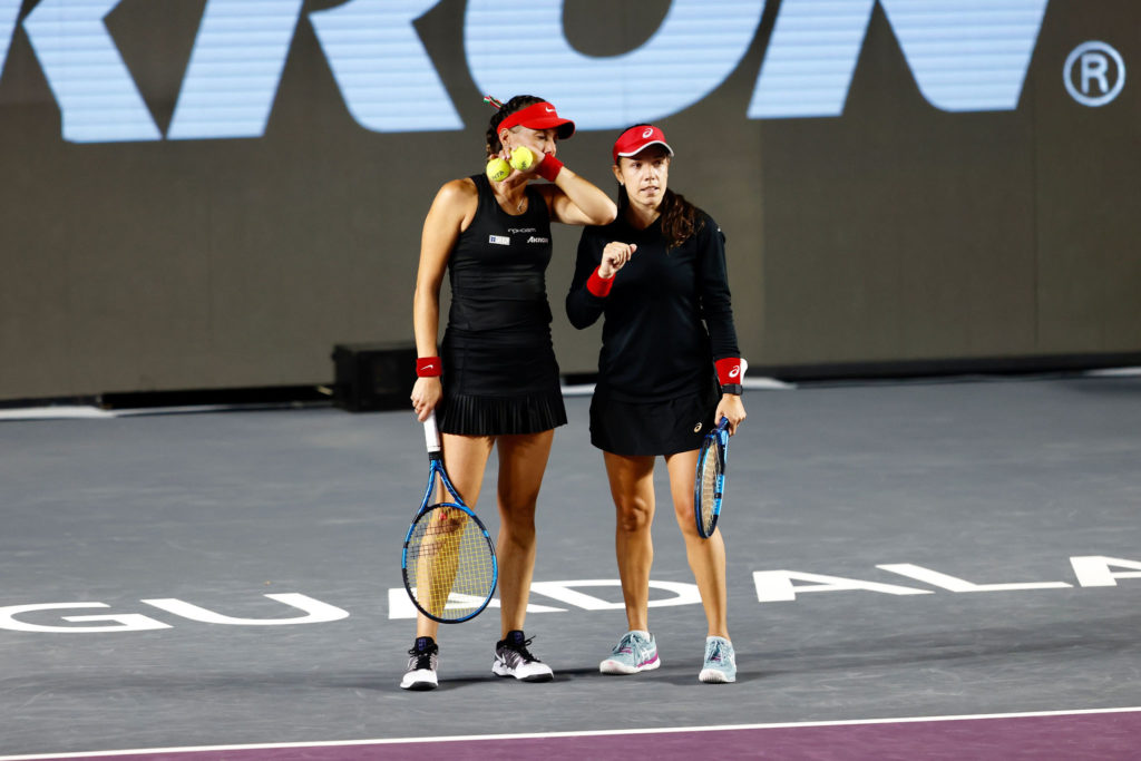 Giuliana Olmos and Sharon Fichman talk during a match.