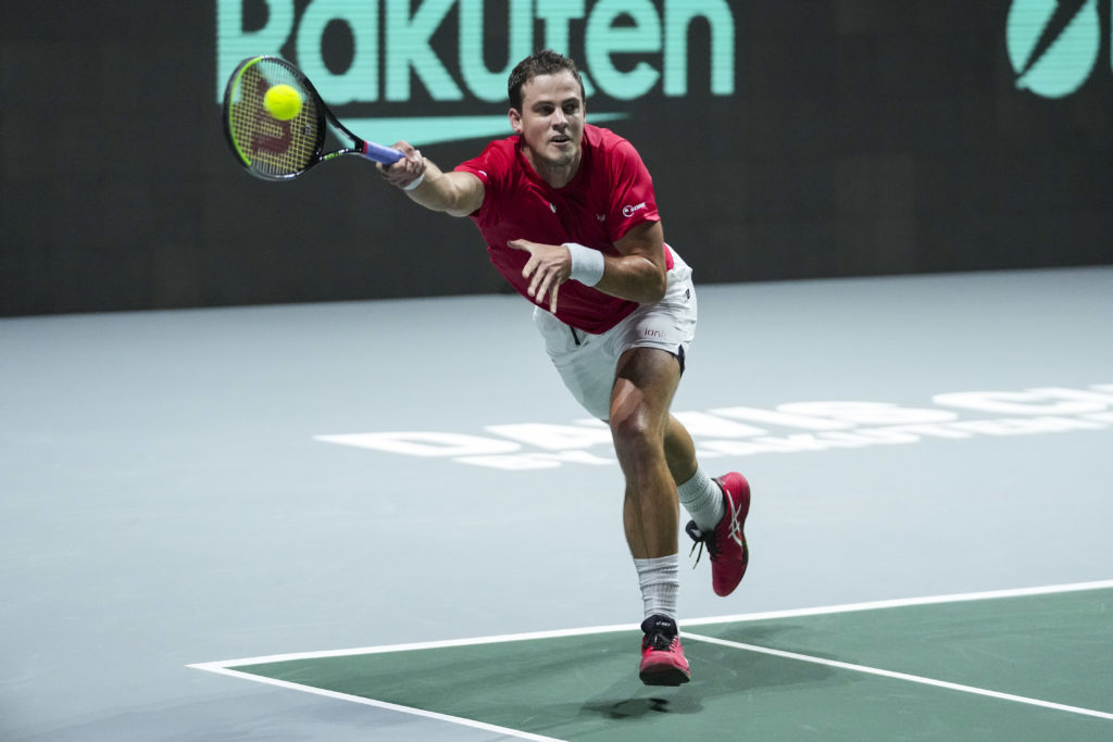 Vasek Pospisil lunges for a forehand.