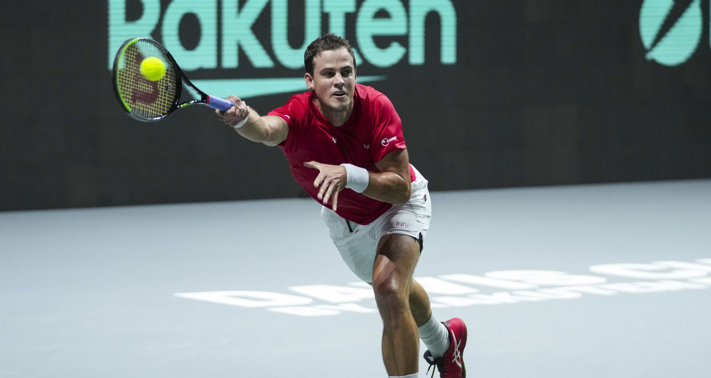 Vasek Pospisil lunges for a forehand.