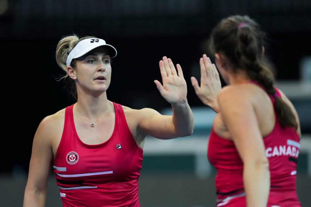Gaby Dabrowski and Rebecca Marino high-five during a Billie Jean King Cup match