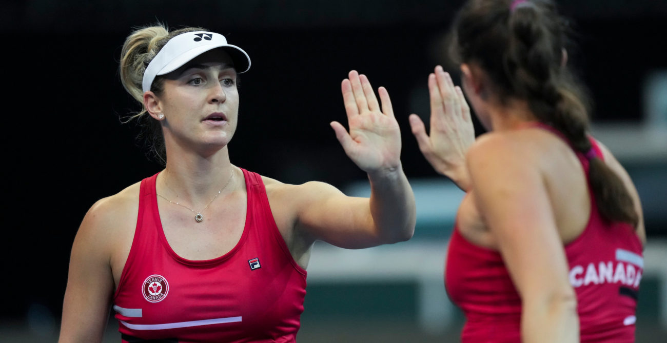 Gaby Dabrowski and Rebecca Marino high-five during a Billie Jean King Cup match