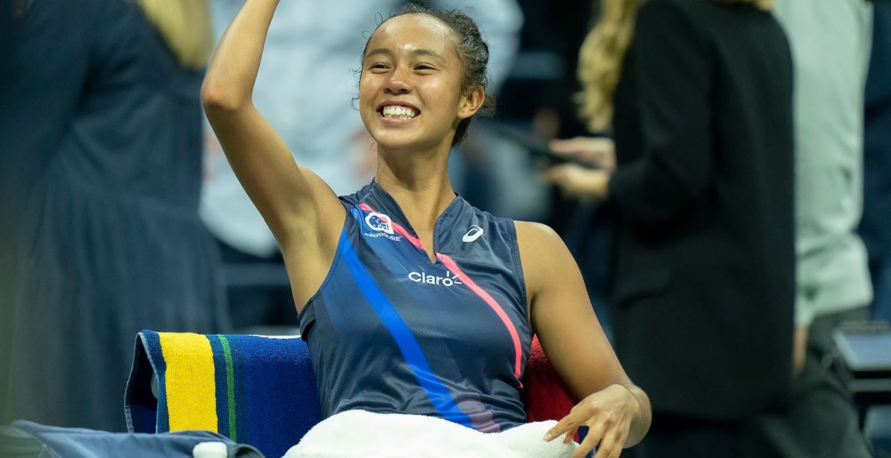 Fernandez lifts her fist and smiles while sitting on her player cair at the US Open