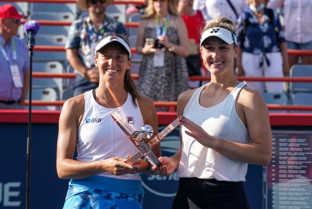 Gaby Dabrowski and Luisa Stefani hold the Canadian Open doubles trophy in 2021