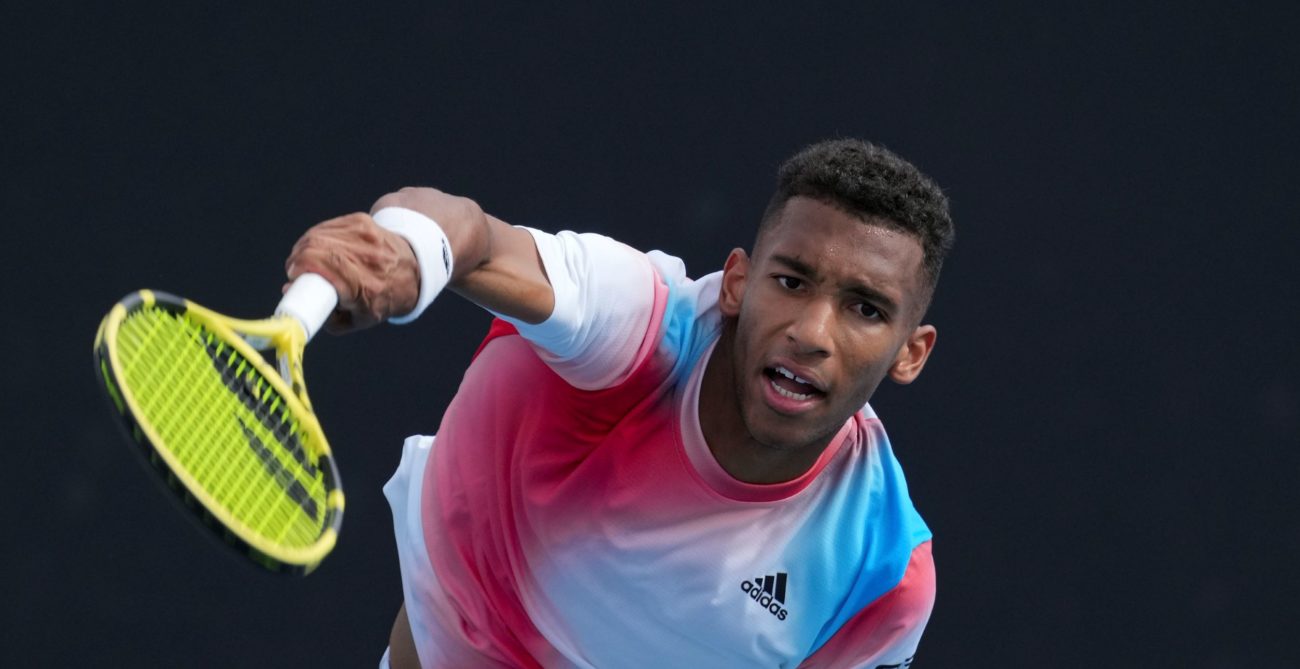 felix auger-aliassime hits volley at the australian open