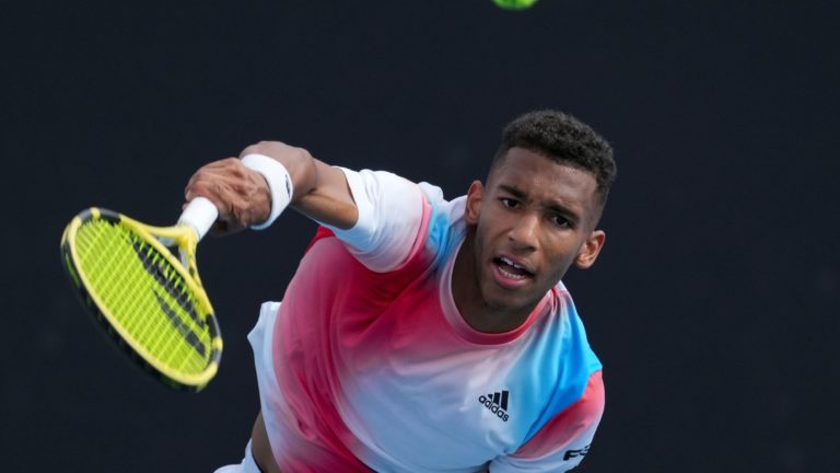 felix auger-aliassime hits volley at the australian open