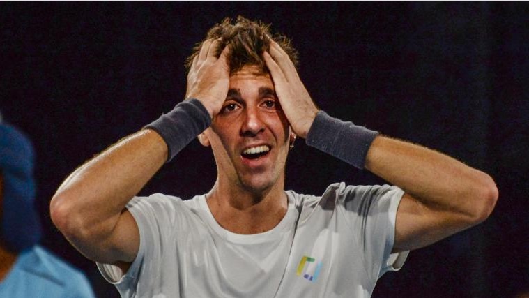 Thanasi Kokkinakis paces hands in his head in disbelief after winning a title