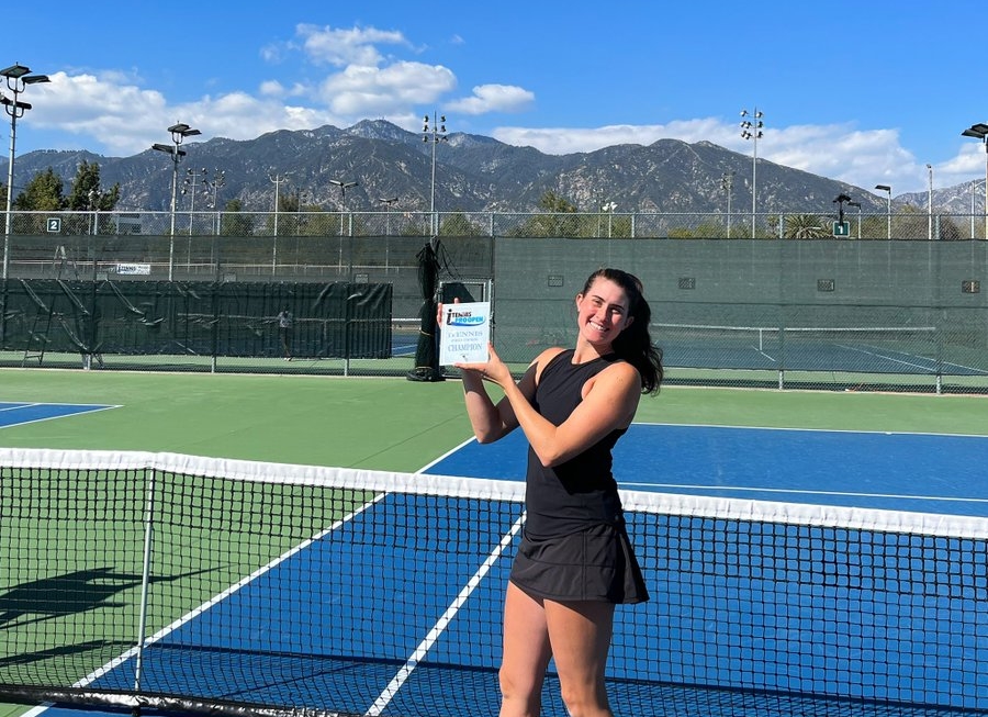 Rebecca Marino holds up her trophy on court.