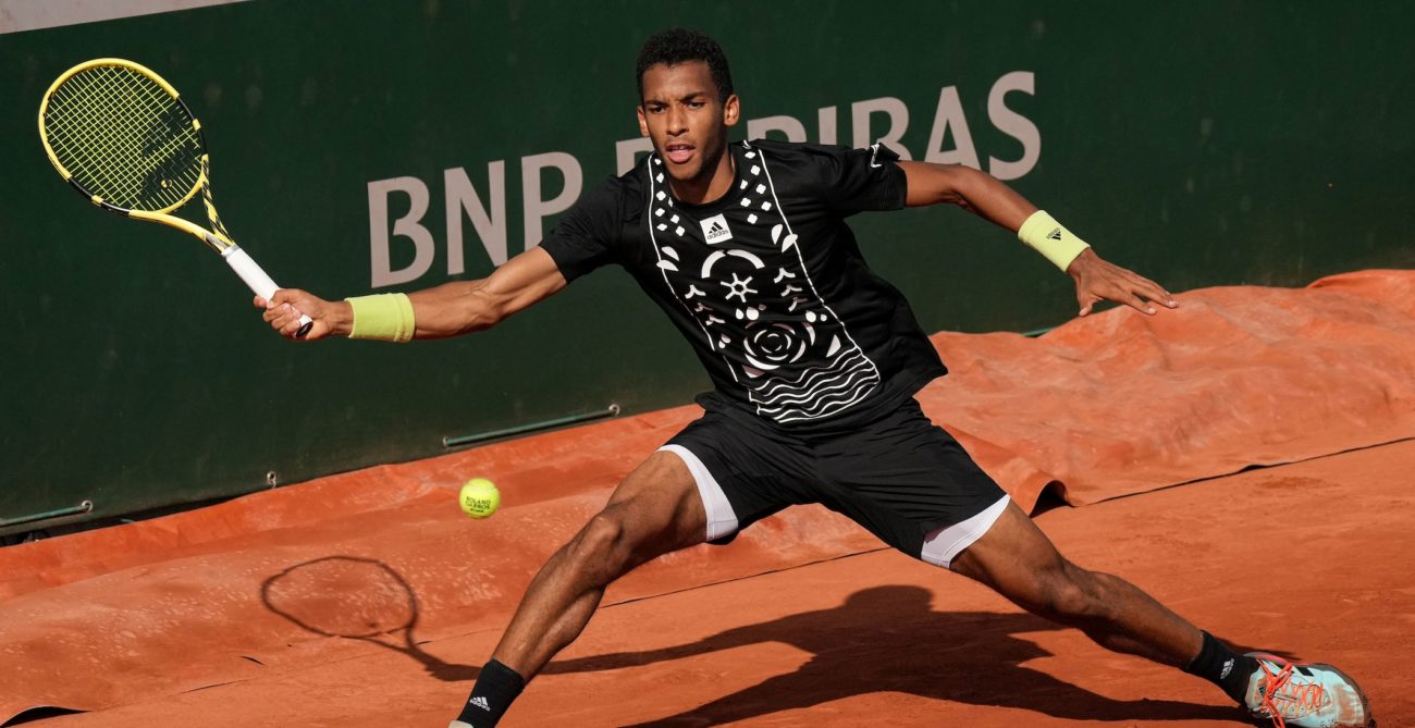 Felix Auger-Aliassime slides into a forehand.