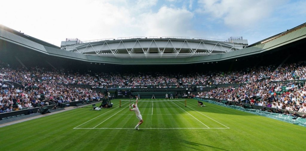 Male player serving on Centre Court