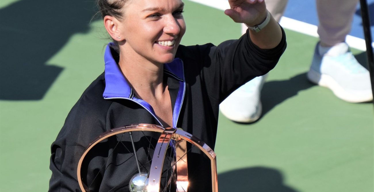 Simona Halep holds the singles trophy.
