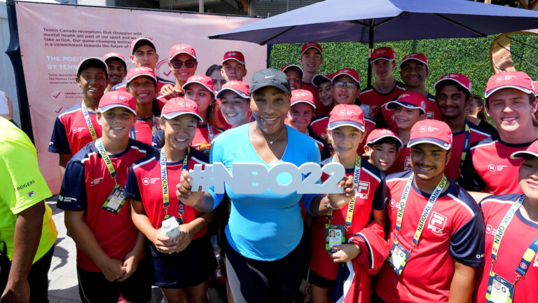 Serena Williams poses for a photo with the ball crew.
