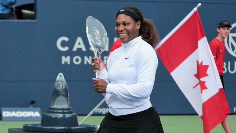 Serena Williams lifts the Rogers Cup trophy.