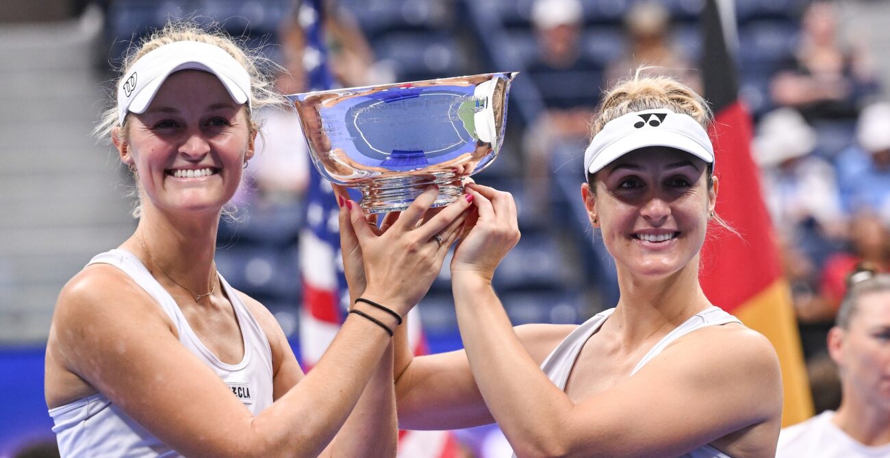 Erin Routliffe (left) and Gabriela Dabrowski hold up the US Open trophy between them.
