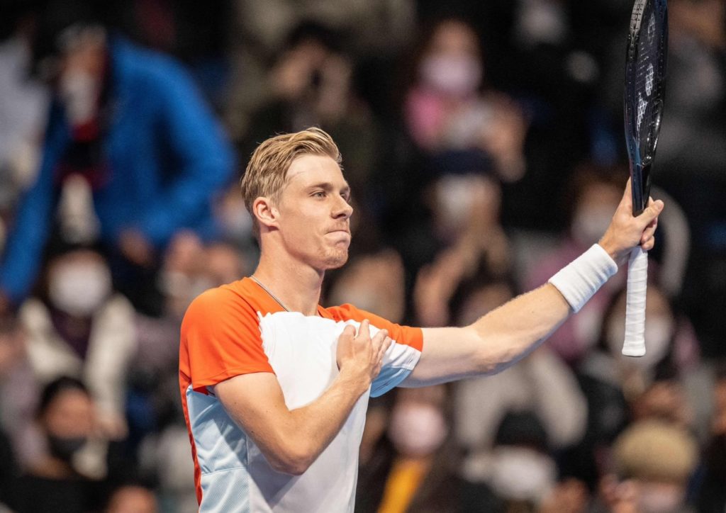 Denis Shapovalov raise his racket and taps his chest to acknowledge the crowd in Tokyo.