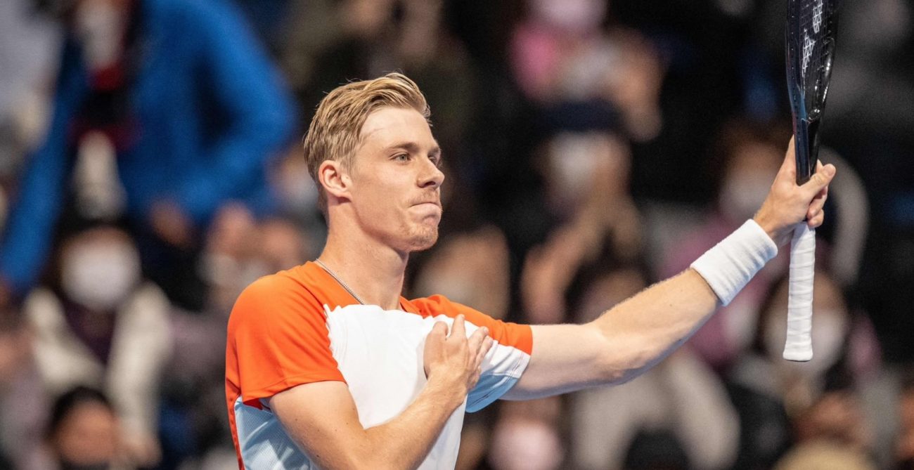 Denis Shapovalov raise his racket and taps his chest to acknowledge the crowd in Tokyo.